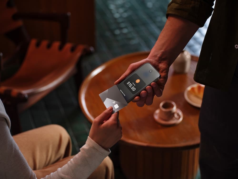 Barista accepting a Tap to Pay payment in a café
